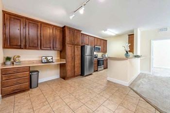 Kitchen with wood cabinetry and tile flooring